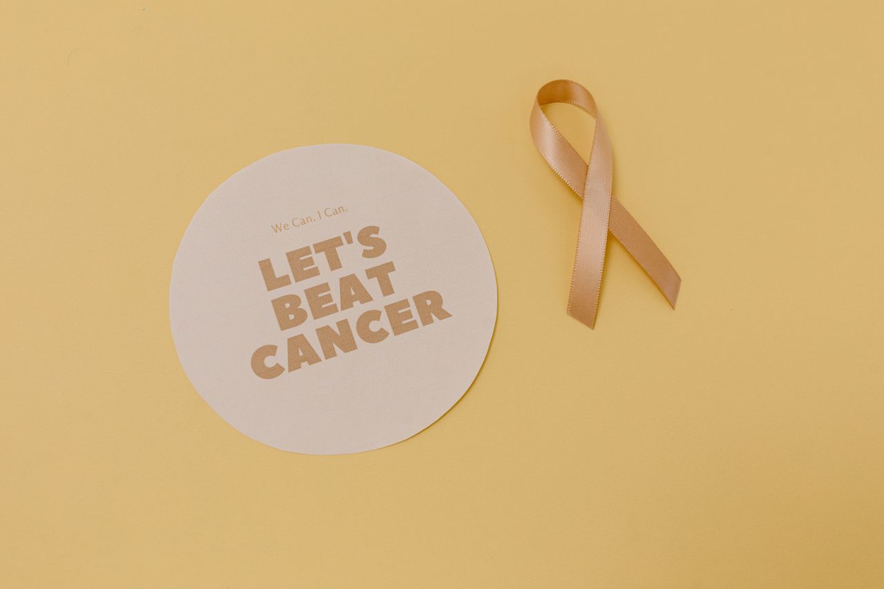 services-01 Flatlay of a cancer awareness ribbon and motivational message, promoting cancer support.